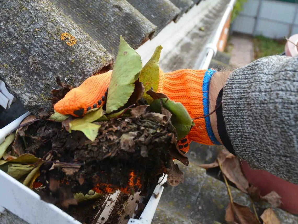 Removing built-up dirt and debris from a gutter